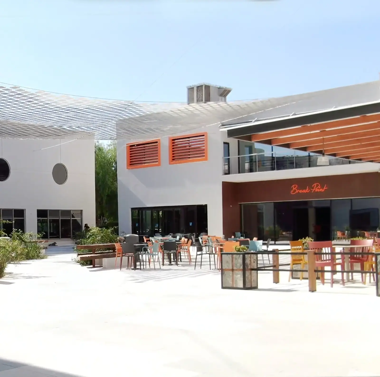 Courtyard café terrace under a shade canopy