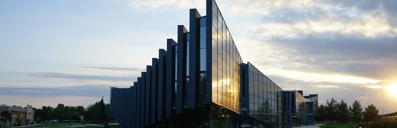 Glass-fronted faculty building at sunset