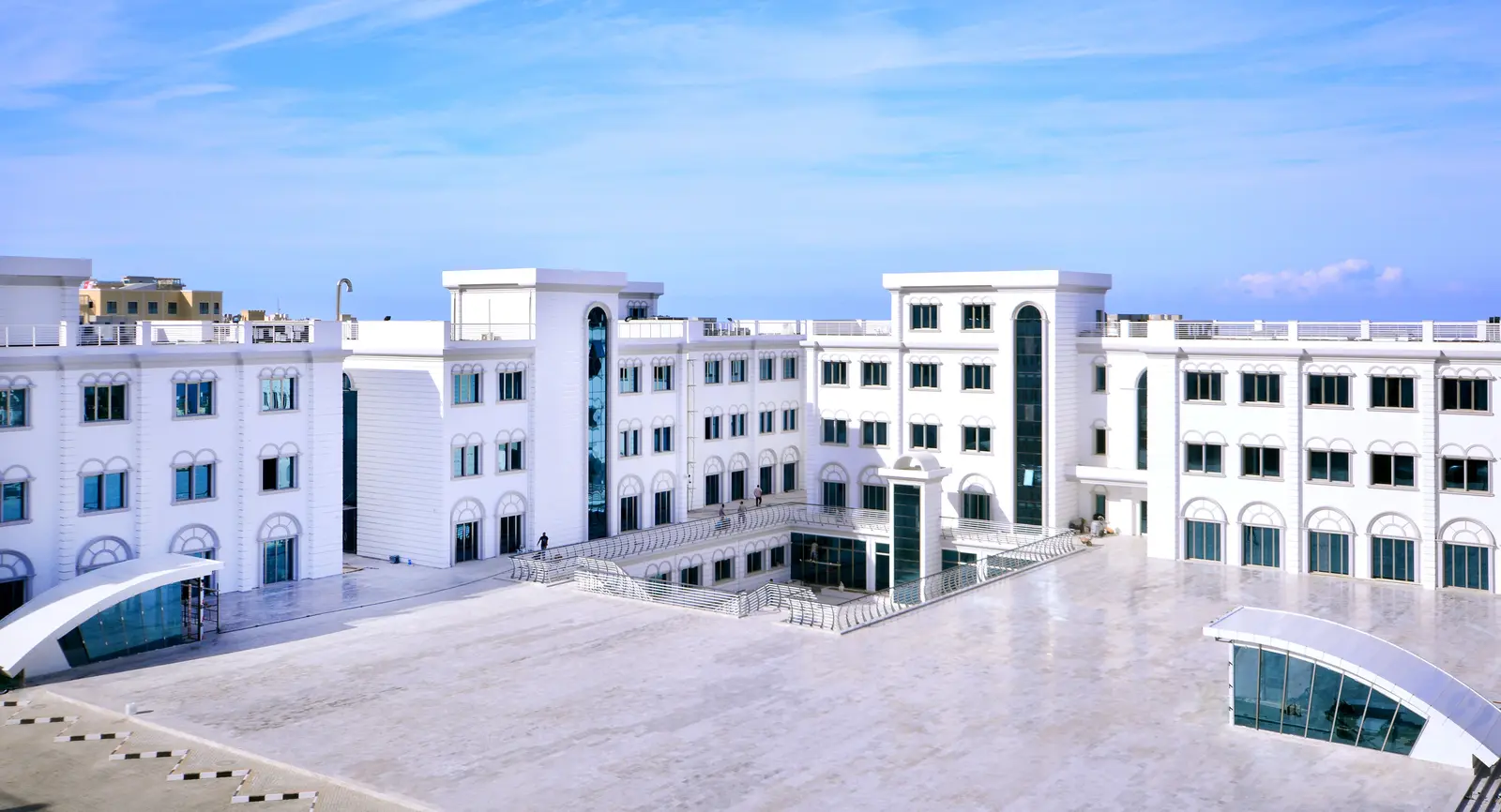 Campus buildings around a paved terrace