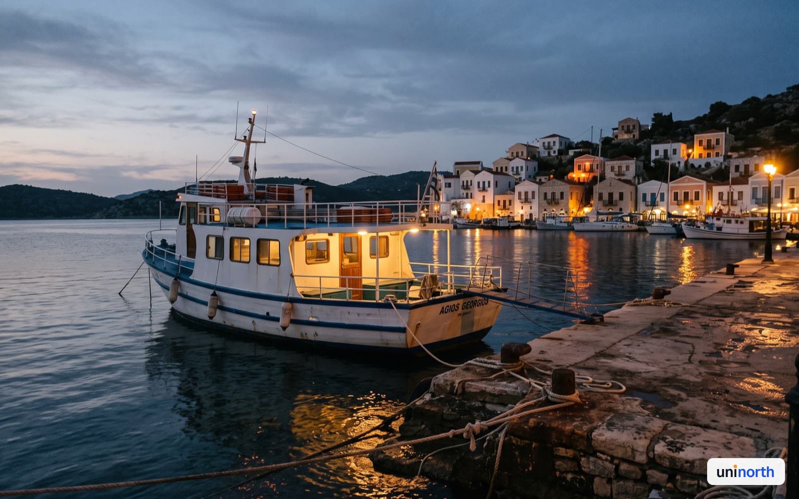 Passenger ferry moored at a Mediterranean harbour at dusk